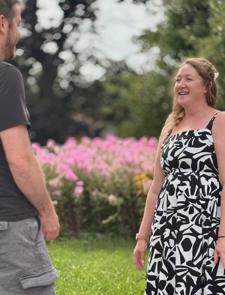 Jenna Jessop talking with a resident outdoors in the community