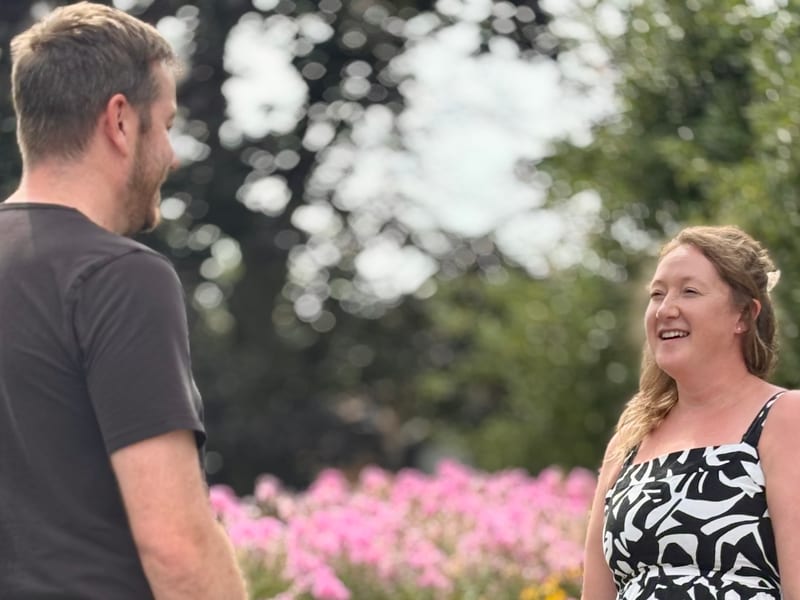 Jenna Jessop talking with a resident outdoors